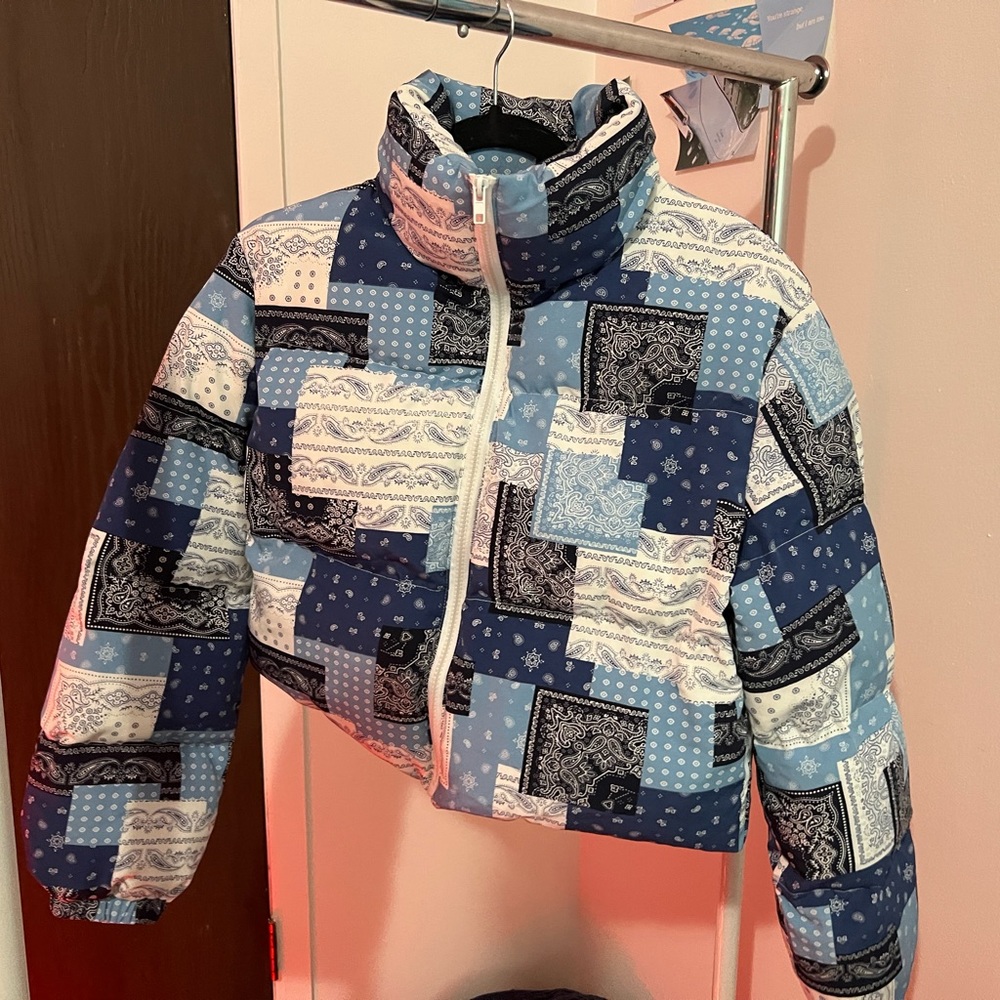A patchwork print zip up puffer jacket